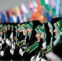 Basij militia with green keffiyeh under chador