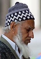 Older man wearing knit kufi