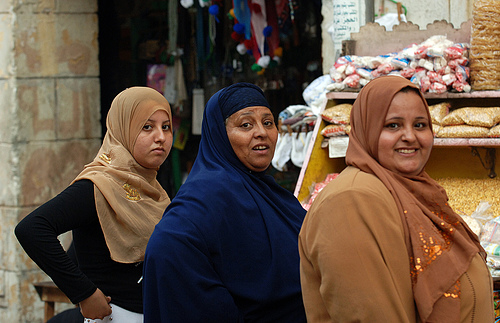 Egyptian women, the lady in the center wears a khimaar. The other women wear shawl-type headcoverings called a shayla